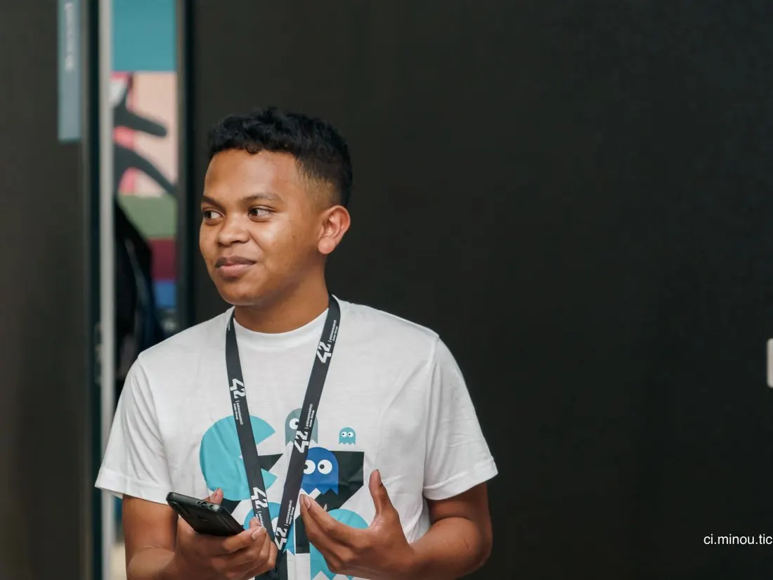 Tolotra Anthony avec le badge de 42 Antananarivo lors d'un événement à l'école